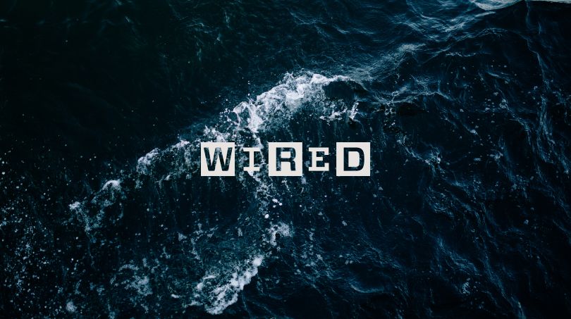 The word 'wired' written with an ocean in the background. 