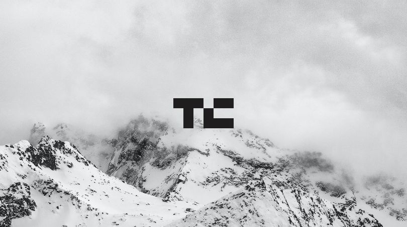 The letters TV written with a snowy mountain top in the background